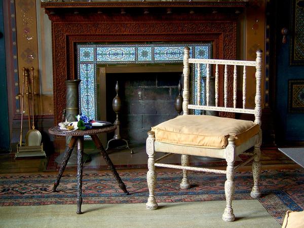 Detail of the interior of the main house at Olana showing a carved teak mantel and hand painted Kashmiri chair provided by de Forest and an Indian table acquired by Church.