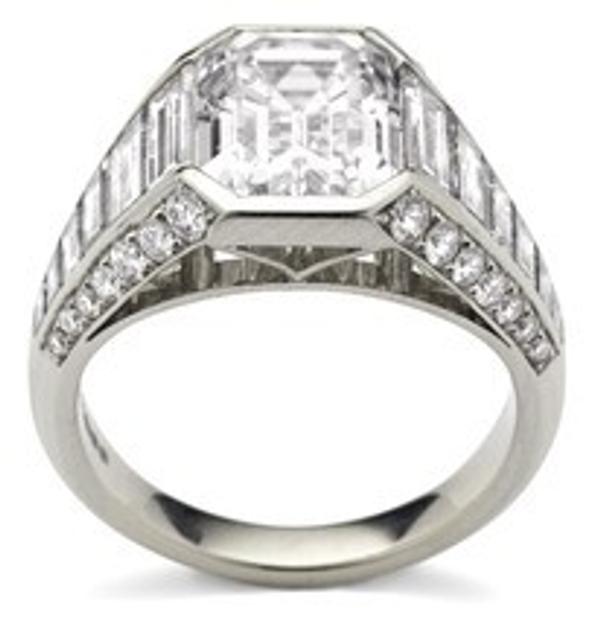 Old Emerald cut diamond ring with tapered diamond and round brilliant diamond shoulders, set in platinum