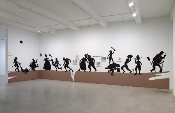 Kara Walker, The Nigger Huck Finn Pursues Happiness Beyond the Narrow Constraints of your Overdetermined Thesis on Freedom - Drawn and Quartered by Mister Kara Walkerberry, with Condolences to The Authors, 2010.  Cut paper and paint on wall and gouache and ink on paper, Approximately 57 feet, 16 cut paper elements, dimensions variable; 7 framed works on paper, each 11 1/2 x 15 inches (29.2 x 38.1 cm).  The Barbara Lee Collection of Art by Women.  Courtesy the artist and Sikkema Jenkins & Co., Ne