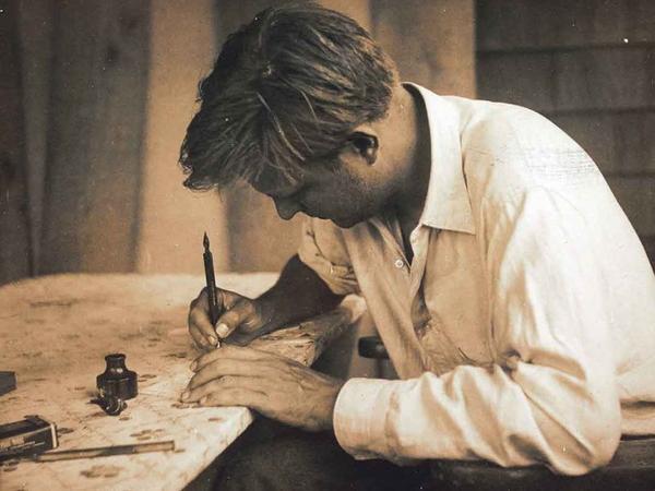 Robert Motherwell writing at his desk in Amagansett, New York, June 1944.