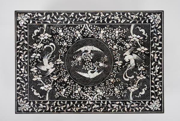 Table with phoenix, crane, and peach motif, 1800–1900.  Korea, Joseon dynasty (1392–1910) Lacquered wood with inlaid mother-of-pearl by Unknown.  On view in "Mother-of-Pearl Lacquerware from Korea" at the Asian Art Museum.