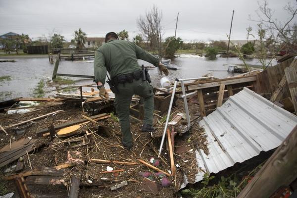 A U.S.  Border Patrol agent searches for survivors in the wake of Hurricane Harvey near Rockport, Texas, on August 27, 2017.