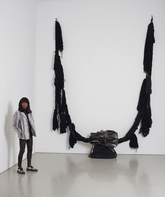 Barbara Chase-Riboud with “The Albino” (aka “All That Rises Must Converge/Black”), 1972, bronze with black patina, silk, wool, linen, and synthetic fibers, 138" x 137" x 30" / 350.5 x 348.0 x 76.2 cm