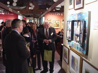 Gala preview attendees have the first choice of works on view.  Photo by Robert Four.