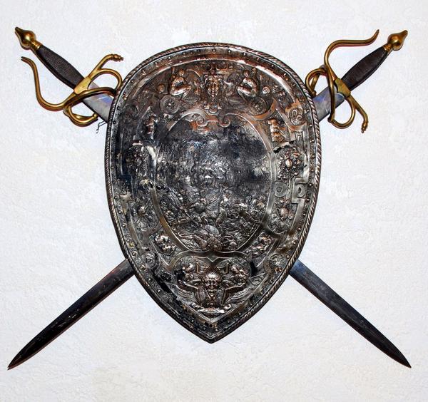 This embossed vintage Belgian shield with crossed swords and carved wood shield with crossed swords, will come up for bid on Saturday, August 29th, in Panama City, Fla.