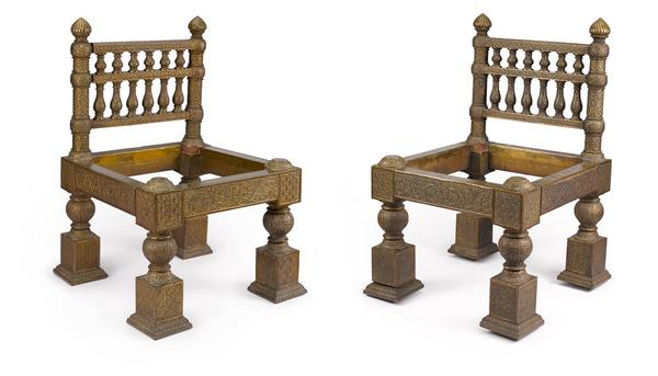 A pair of chased brass-overlaid teak chairs designed by Lockwood de Forest (1850-1932).  India, 1881-1882.  Estimate $ 50,000 - 80,000