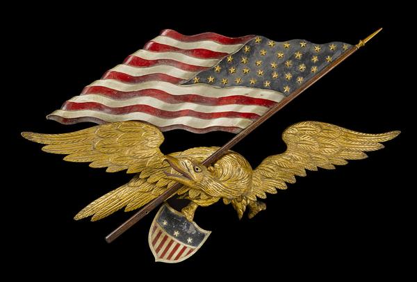 A carved and polychromed wing-spread eagle with flag and shield attributed to George Stapf (American, 1862-1958) probably Harrisburg, Pennsylvania, 1890-1910.  Est.  $8,000-12,000.