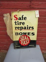 Bowes Fast Seal Tire Repair sign.  Painted tin and single-sided.  There are some bends in the sign.  22 inches by 34 inches.