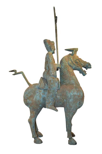 Massive archaic Chinese bronze statue of man on horseback.  Eastern Han Dynasty.