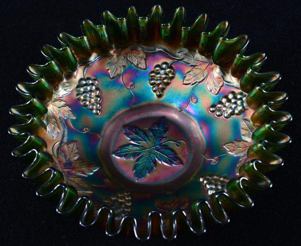 This stunning ribbon-edged Carnival bowl with leaf and grape design, 7.5 inches in diameter, will be sold April 25 in Panama City, Florida,