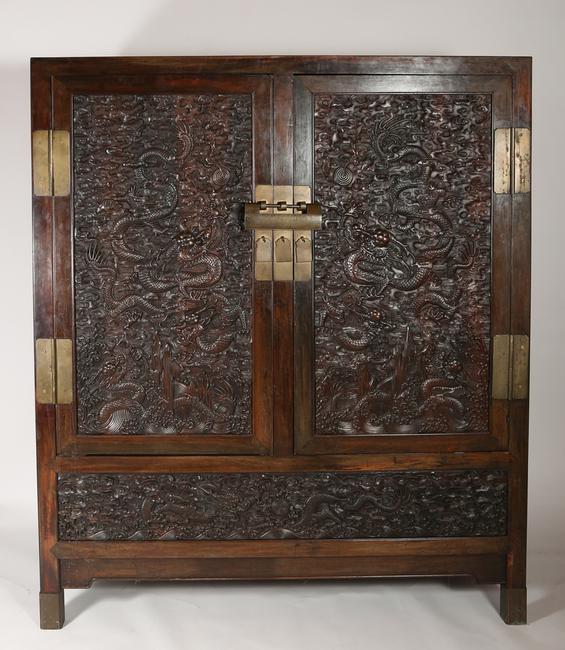 An 18th century Chinese Zitan Cabinet with Dragon Carved Panels, with later additions