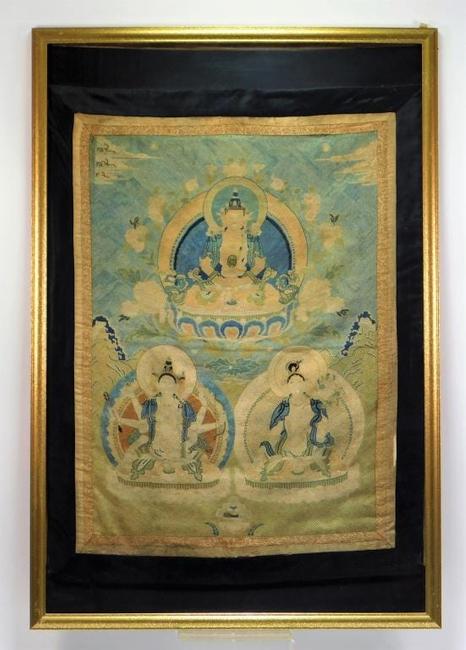 Chinese Qing Dynasty (1644-1912) or earlier embroidered tapestry depicting three Buddha figures seated on lotus thrones, nicely housed in a 37 ¾ inch by 25 ½ inch frame ($12,500).