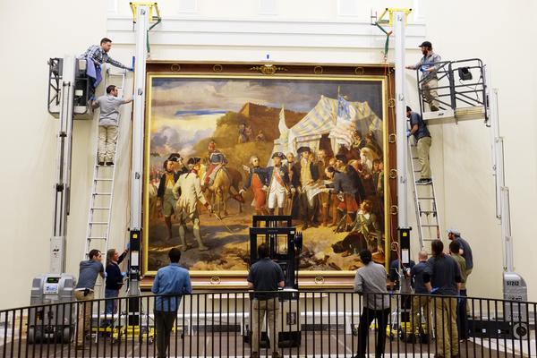 A copy of French artist Louis Charles-Auguste Couder’s Siege of Yorktown (1781) being installed at the Museum of the American Revolution.