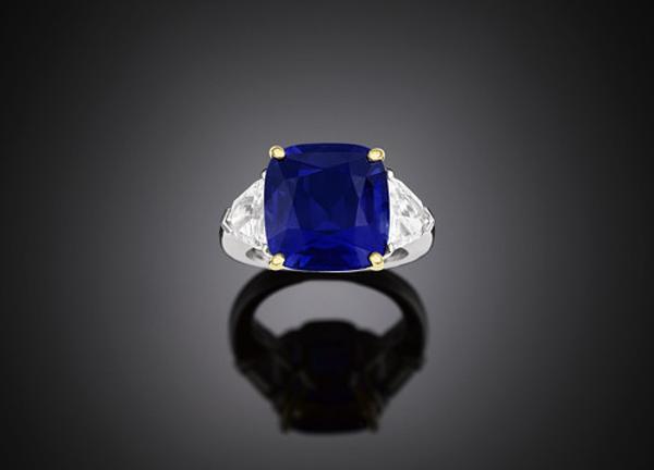 This $2,250,000 intense blue Kashmir sapphire is 14.44 carats, remarkably flawless and a deep blue color.  It is set in platinum along two trapezoid diamonds each 2.08 carats.