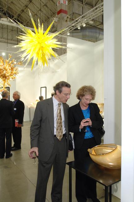 Guests admiring the work of Dale Chihuly in the Holsten Galleries booth at SOFA CHICAGO.