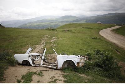 Eduard Korniyenko, A view on the remains of body shell of Lada car near the road in the mountains of Dagestan, Epson Premium Luster 260,