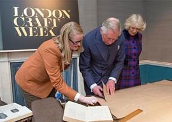 HRH The Prince of Wales with The Duchess of Cornwall, tries his hand at pattern cutting with tailor Kathryn Sargent.