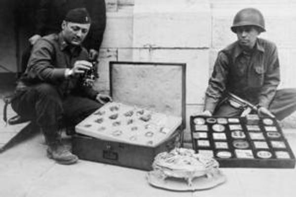 First Lieutenant James J.  Rorimer, at left, and Sergeant Antonio T.  Valin examine recovered objects.  Neuschwanstein, Germany, May 1945.  Photograph by U.S.  Signal Corps