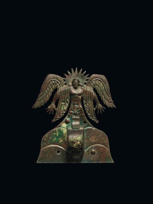 Appliqué depicting the Sun God Usil, Etruscan, 500 - 475 B.C.  Italy, made in Vulci.  Bronze.  H: 20 cm (7 7/8 in.) The J.  Paul Getty Museum, Villa Collection, Malibu, California