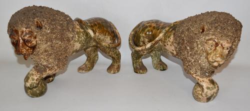 Pair of rare flint enamel Bennington Rockingham glaze lions by Lyman, Fenton & Company, circa 1840-1850, 7 ¾ inches tall by 11 inches wide.