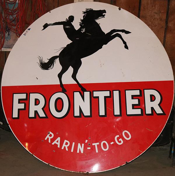 Late 1950s Frontier Gasoline “Rarin’-to-Go” single-sided porcelain gas station sign, six feet in diameter, in excellent condition, with a graphic of a cowboy on a bucking bronco ($5,375).