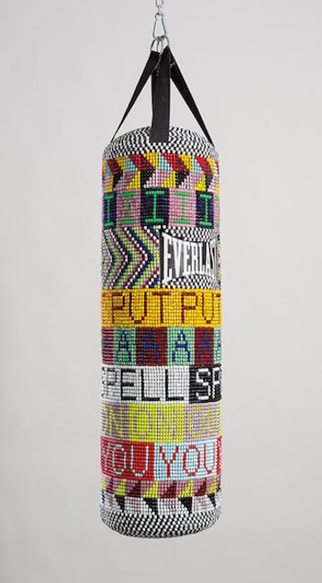 Jeffrey Gibson (Mississippi Band Choctaw/ Cherokee), I PUT A SPELL ON YOU, 2015.  Repurposed punching bag, glass beads, artificial sinew, and steel; 40 × 14 × 14 in.  Collection of the Nasher Museum of Art at Duke University, Durham, North Carolina.  Museum purchase, 2015.11.1.  Image courtesy of Jeffrey Gibson Studio and Roberts Projects, Los Angeles, California.  Photograph by Peter Mauney.  