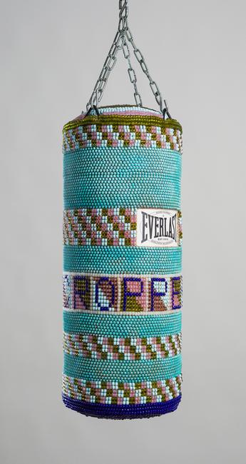 Jeffrey Gibson (b.  1972), Sharecropper, 2015.  repurposed punching bag, glass beads, oxidized copper beads, artificial sinew, steel.  30 x 12 ½ x 12 ½ in.  Collection of Mississippi Museum of Art, Jackson.  Museum purchase with W.K.  Kellogg Foundation funds for the Center for Art & Public Exchange.  2017.098.  © 2018 Jeffrey Gibson; Courtesy of Marc Straus Gallery, New York.