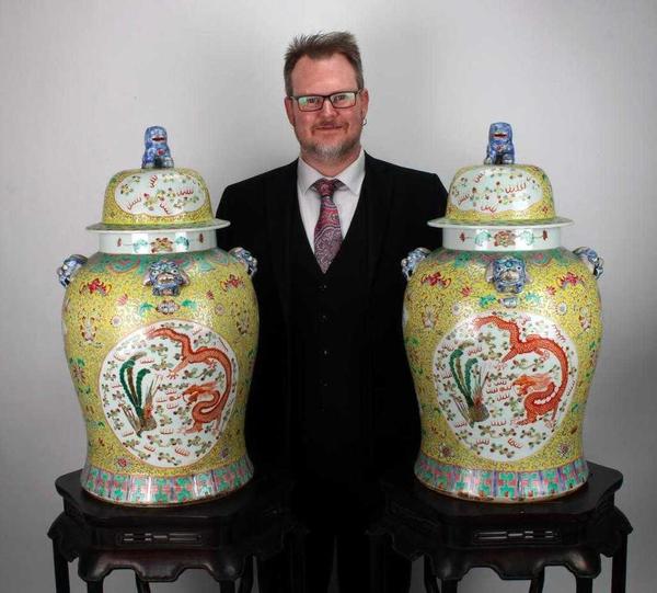 Large pair of famille jaune (yellow Chinese porcelain) dragon and phoenix ginger jars with foo dog finials on the lid, 14 inches tall (est.  $2,000-$4,000).