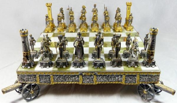 Beautiful gilt metal chess set and board by the Italian visual artist and sculptor Giuseppe Vasari (1934-2005), depicting the Battle of Waterloo, artist signed (est.  $2,000-$3,000).