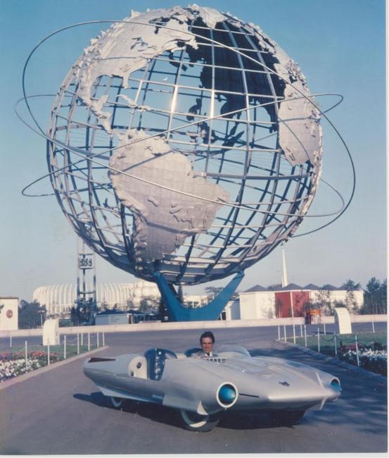 Concept car designer/fabricator John Bucci (Italian/American, 1935-2019) at the 1964 New York World’s Fair, where his 1962 fiberglass car ‘La Shabbla,’ thrilled millions of visitors at the Cavalcade of Cars exhibition.  The car is entered in an online-only auction with bidding through October 14.  Estimate $50,000-$75,000.  Archival photo from the Estate of John Bucci.  