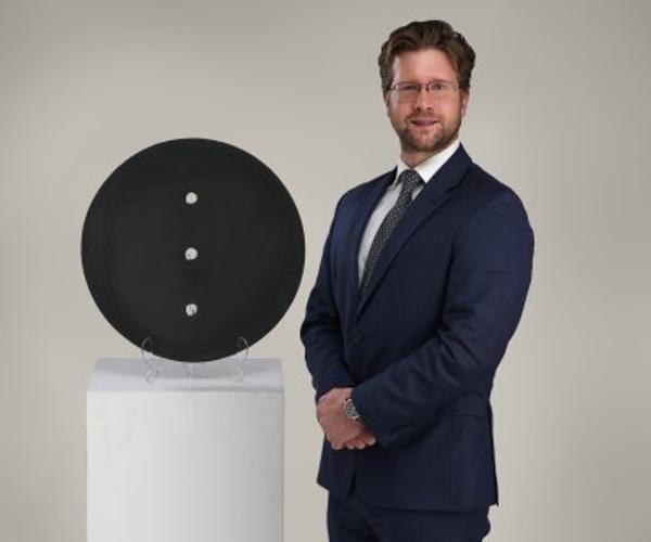 Malyk pictured with Lucio Fontana’s “Concetto Spaziale,” which will be offered in the May 1 Modern & Contemporary Art auction