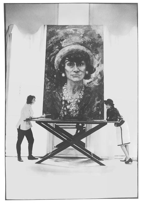 Artist Marion Pike with Coco Chanel with a painting by Pike of Chanel.