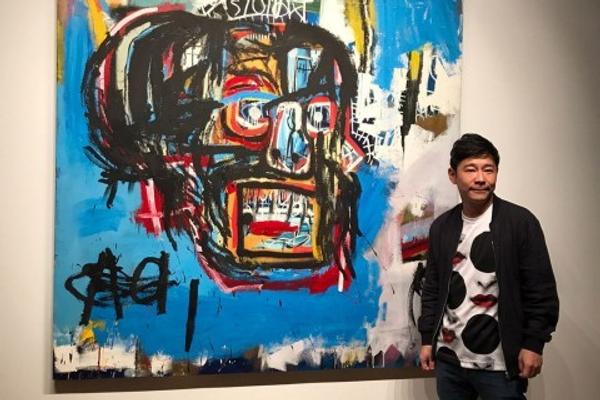 Yusaku Maezawa poses with Basquiat's Untitled (1982).