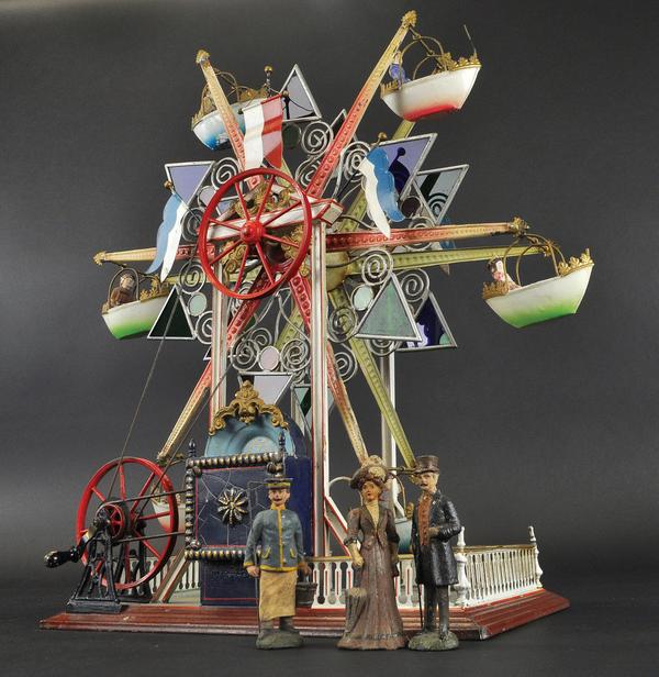 This extremely rare circa 1902 Marklin Ferris Wheel features six (6) exquisitely carved and painted gondolas and center box with musical movement.  Coming from the private collection of Jeanne Bertoia, the current value of this piece is estimated between $75,000 and $100,000.