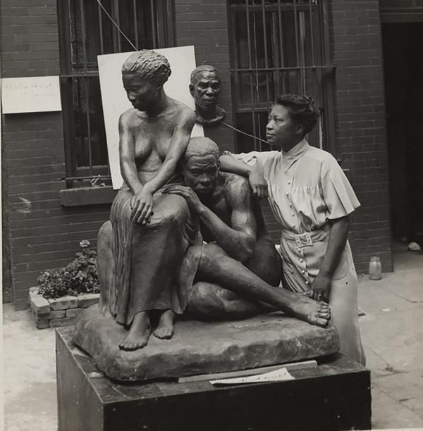 Andrew Herman (active 1930s–1940s), Federal Art Project, Works Progress Administration, Augusta Savage with her sculpture Realization, 1938.  Schomburg Center for Research in Black Culture, NYPL, Photographs and Prints Division, Astor, Lenox and Tilden Foundations, 86-0036.