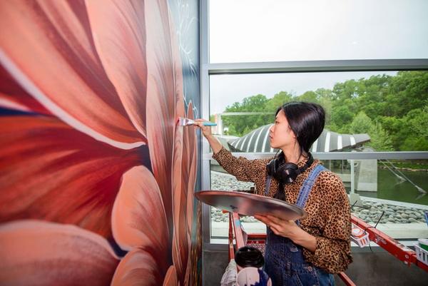 Louise Jones working on her 30-foot mural for 