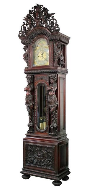 The top lot of the auction at $90,750 was this R.J.  Horner mahogany grandfather clock with J.J.  Elliott nine-tube works, heavily carved with winged griffins, pierced carved angel crest, flowers, foliage and birds.  It stands 118 1/2 inches tall.