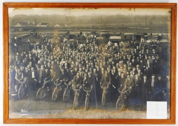 Large group photo taken around 1911 of Henry Street Garage telephone linemen, some shown seated on motorcycles, cars and horse-drawn carriages ($2,000).