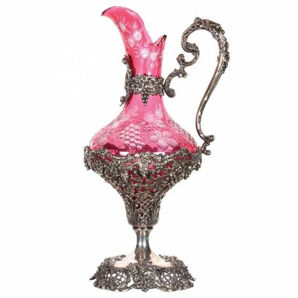 Museum-quality cranberry cut to clear Dorflinger ewer, 17 inches tall, with an extensive pattern embossed sterling silver base, body and handle ($75,000).