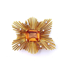 Custom-made 18kt yellow gold, imperial topaz and diamond brooch of sunburst form, with undulating golden rods set with seven brilliant cut diamonds (est.  $12,000-$15,000).