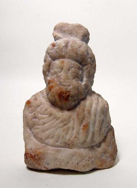 Roman marble bust of the popular deity Serapis from the 1st-3rd Century AD, robed with a heavy beard, a modius atop his head, standing a little more than 6 inches tall (est.  $1,500-$2,500).