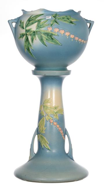 Roseville art pottery two-part jardiniere and pedestal in the Bleeding Heart pattern, 32 inches tall.