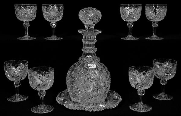 Cut glass decanter with underplate and eight matching wine glasses, in the Chrusanthemm pattern by Hawkes.