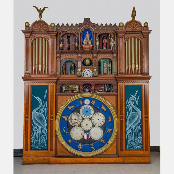 Automatic Wonder Steinle’s Sandusky clock, circa 1897, having numerous animated figures, with a painted banner of the clock, 12 feet tall by 9 feet 4 inches wide (est.  $6,000-$8,000).