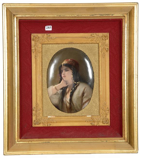 This marked KPM German oval porcelain plaque showing a portrait of a young Arab woman, in a gilt wooden frame, will be sold on Feb.  21.