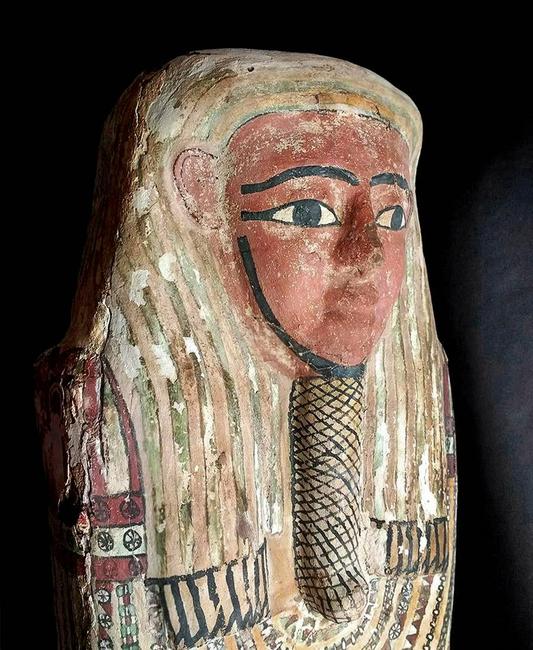 Egyptian polychrome gesso coffin lid, 26th to 31st Dynasty, circa 664-332 BCE, 74in long.  Depiction of a serene countenance atop a densely decorated body.  Estimate $100,000-$150,000