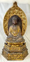 19th century carved and giltwood Buddha temple figure raised on a lotus base with pedestal.  Estimate: $400-$600.