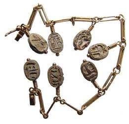 Fantastic 21kt yellow gold scarab bracelet, handsomely constructed with seven Egyptian steatite scarabs of similar size and shape, all but one from the New Kingdom (est.  $600-$900).