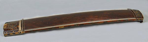 An early Meiji period Japanese Koto musical instrument with intricate inlays, silver and gilt lacquer and applied metal decoration, measuring 11" wide, 75 1/2" long