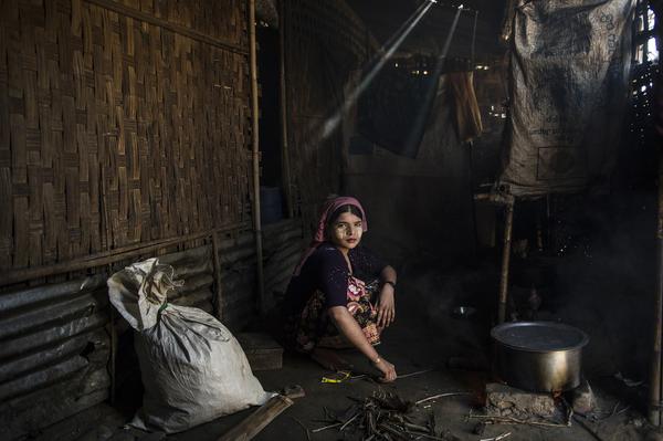 Say Tha Mar Gyi, Myanmar, 2015: A.  cooks in her family home in Say Tha Mar Gyi Camp.  She is married, but her husband left her within the last year to return to his family.  ©Lynsey Addario